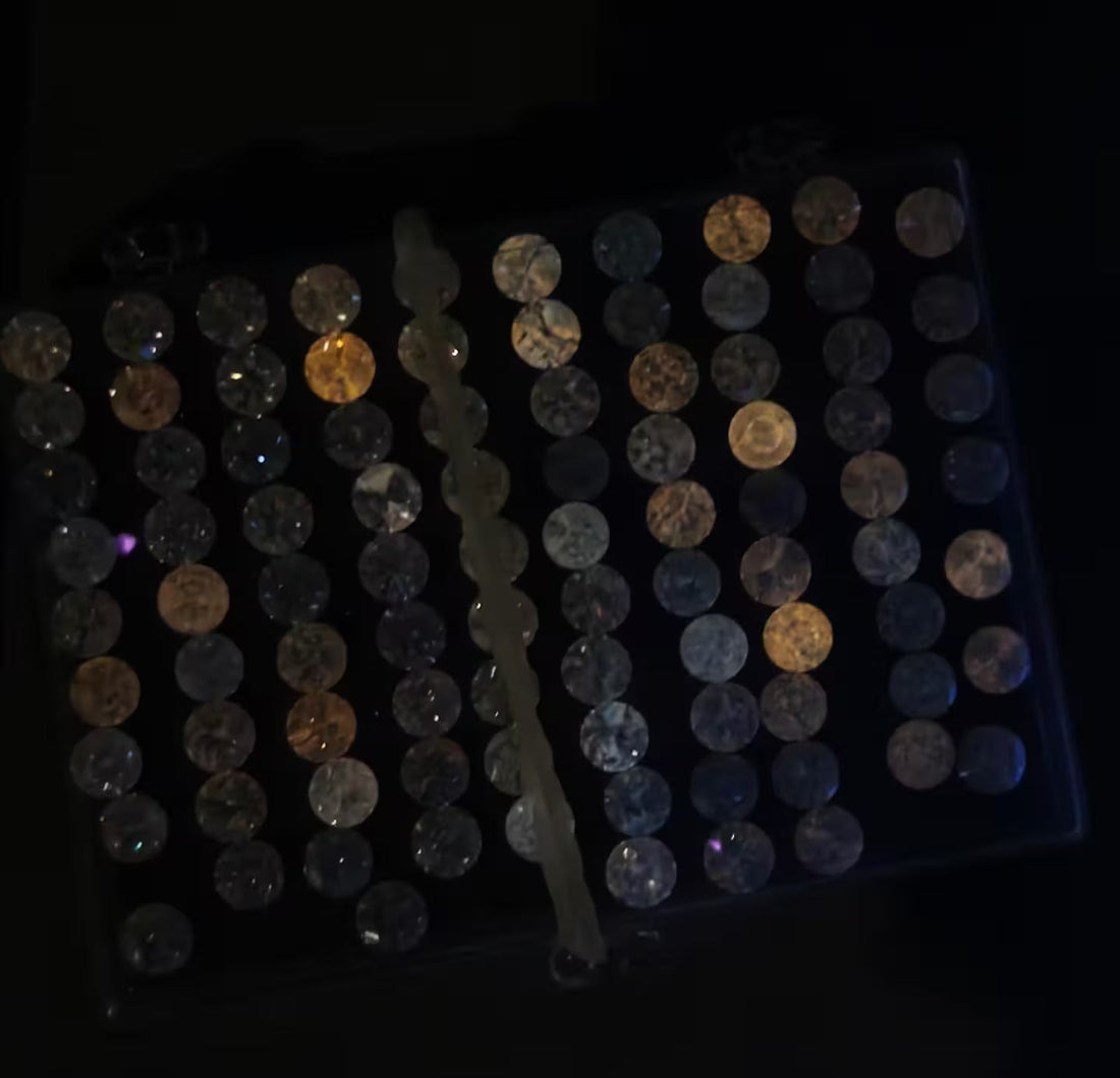 : A lab-grown diamond comparison chart displaying a spectrum of phosphorescence intensity levels under ultraviolet light, ranging from non-reactive to a strong, visible glow.